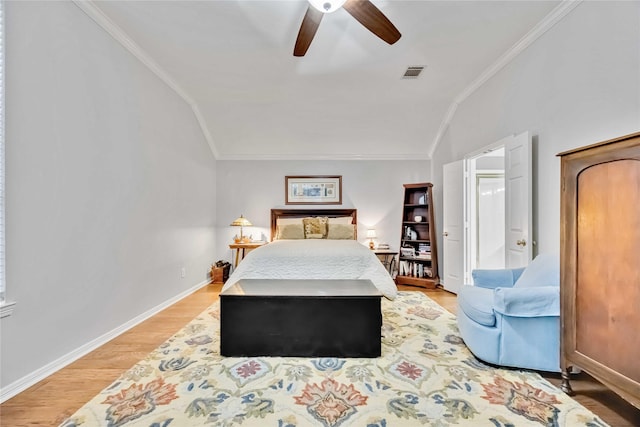 bedroom featuring crown molding, wood-type flooring, ceiling fan, and vaulted ceiling