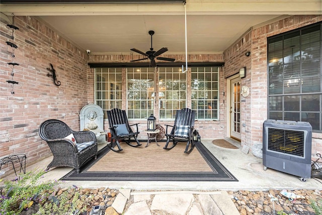 view of patio with heating unit and ceiling fan