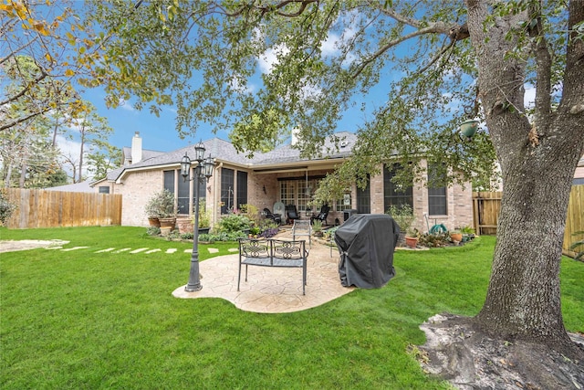 back of property featuring a patio and a lawn