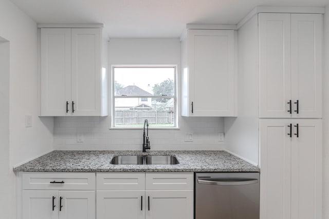 kitchen featuring sink, light stone countertops, white cabinets, and dishwasher