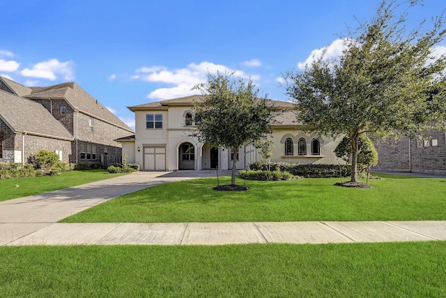 mediterranean / spanish-style house featuring a garage and a front yard