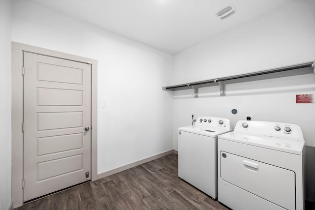 laundry room featuring dark hardwood / wood-style floors and washer and clothes dryer