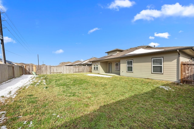 rear view of house featuring a lawn and a patio area