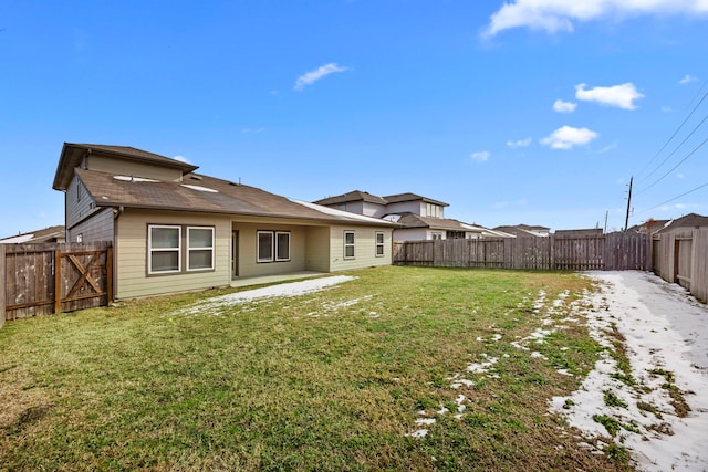 back of property with a yard and a patio area