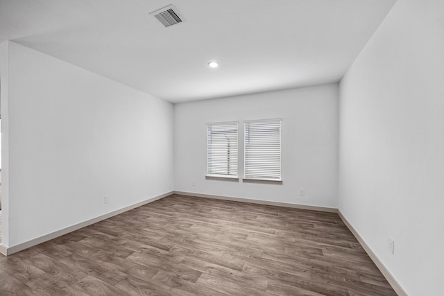 spare room featuring hardwood / wood-style floors