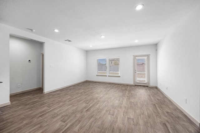 spare room featuring hardwood / wood-style flooring