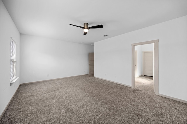 spare room with ceiling fan and carpet