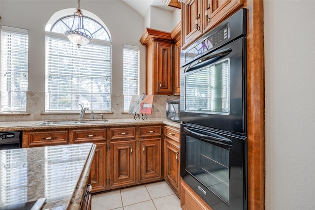 kitchen featuring decorative light fixtures, tasteful backsplash, sink, light tile patterned floors, and black appliances