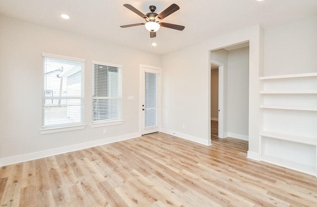 empty room featuring light hardwood / wood-style flooring and ceiling fan