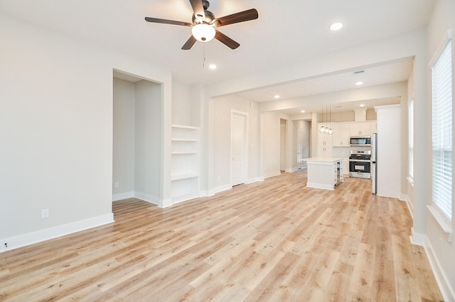 unfurnished living room with ceiling fan, light hardwood / wood-style floors, and built in shelves