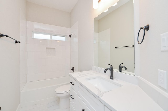 full bathroom featuring vanity, tiled shower / bath, and toilet