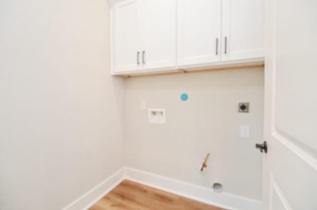 washroom featuring cabinets, hookup for a washing machine, hookup for an electric dryer, and hardwood / wood-style flooring