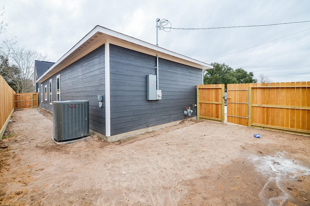 view of side of home with central AC