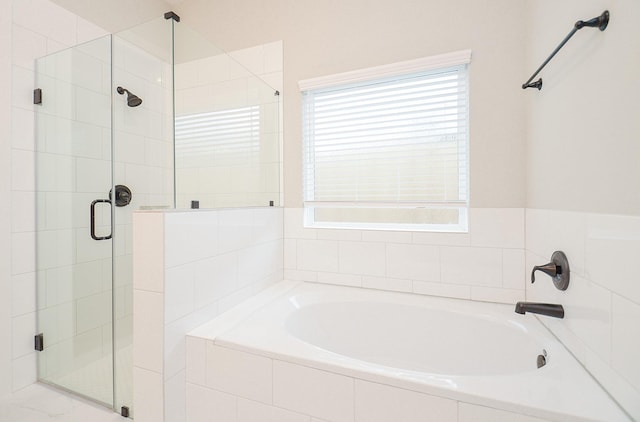 bathroom featuring separate shower and tub