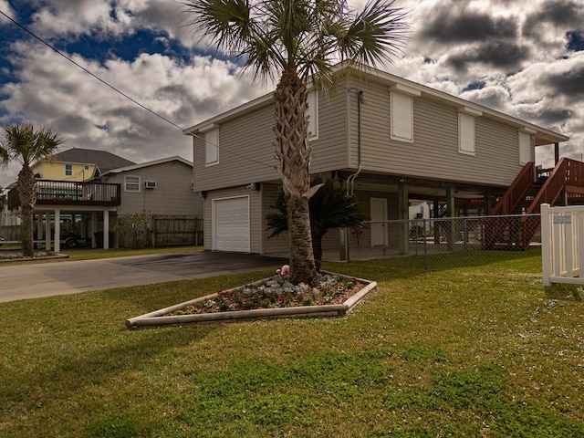 16527 Nassau Way, Jamaica Beach, TX 77554 - view of front facade featuring stairway, concrete driveway, fence, a front lawn, and a garage