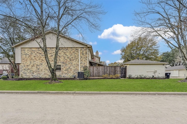 view of property exterior with central AC and a lawn