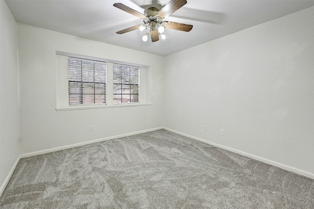 spare room featuring ceiling fan and carpet