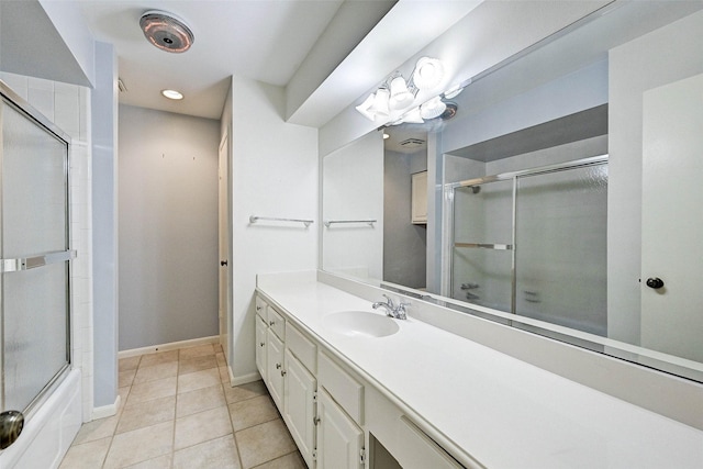 bathroom with vanity, bath / shower combo with glass door, and tile patterned flooring