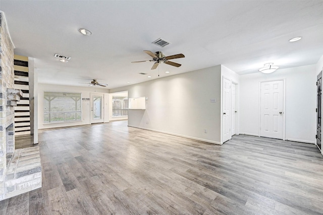 unfurnished living room with ceiling fan and light hardwood / wood-style flooring