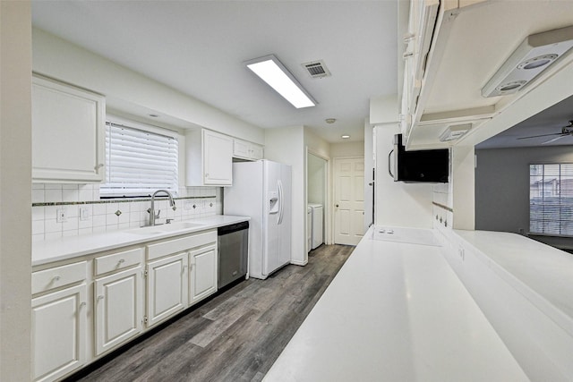 kitchen with dark wood-type flooring, sink, dishwasher, white fridge with ice dispenser, and white cabinets