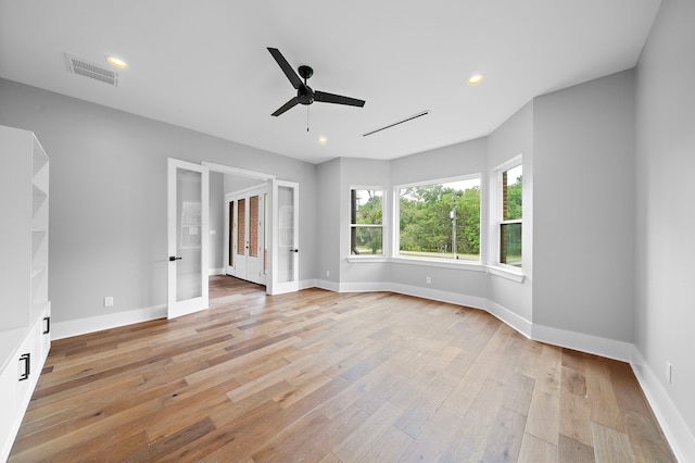 unfurnished room with light hardwood / wood-style flooring, french doors, and ceiling fan