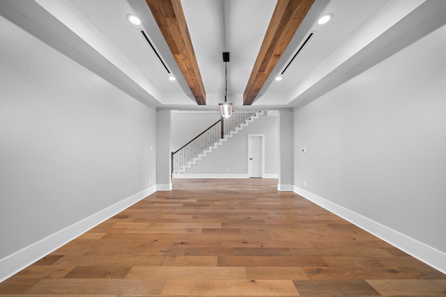 interior space featuring hardwood / wood-style floors and beamed ceiling