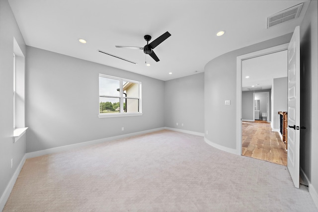 carpeted spare room featuring ceiling fan