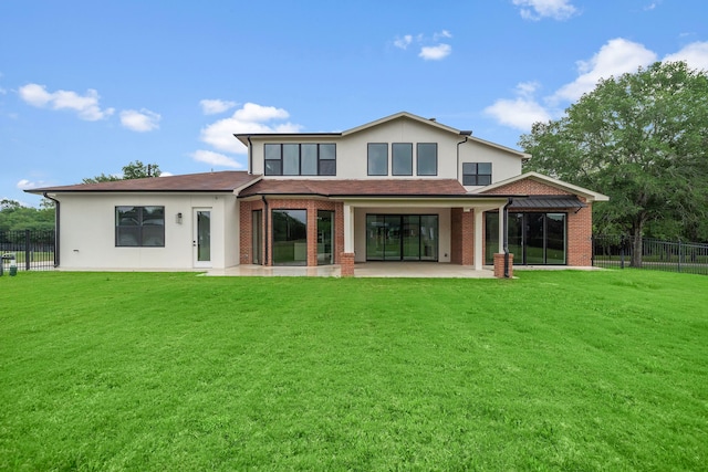 back of house featuring a patio and a lawn