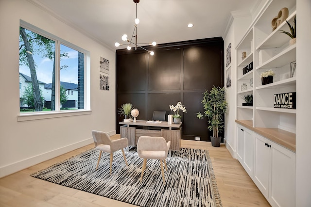 office featuring ornamental molding, a healthy amount of sunlight, a notable chandelier, and light wood-type flooring