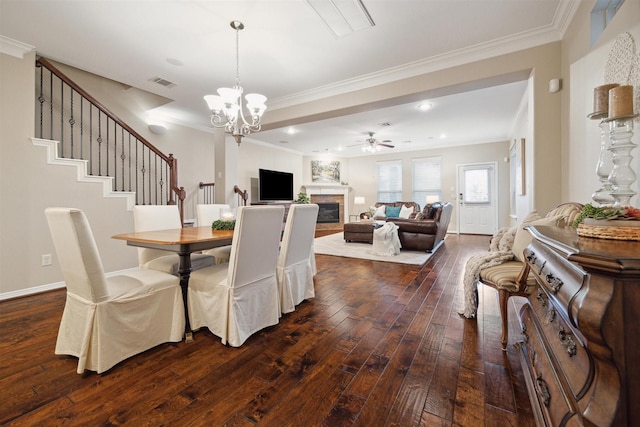 dining room with crown molding, dark hardwood / wood-style floors, and ceiling fan with notable chandelier