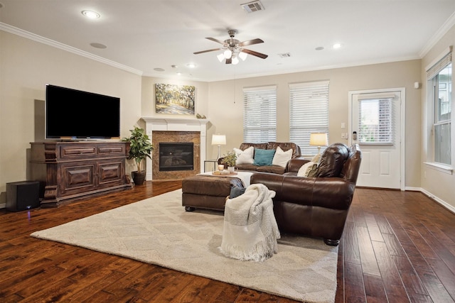 living room with ornamental molding, dark hardwood / wood-style floors, and ceiling fan