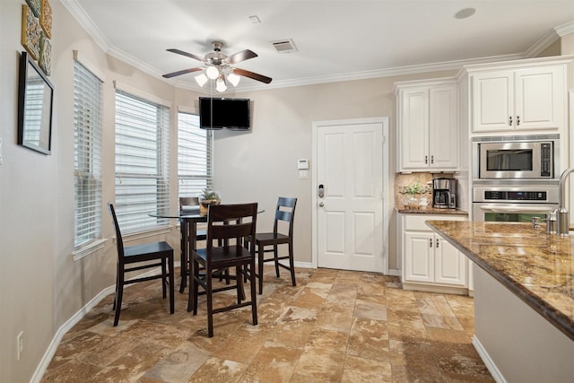 dining room featuring ornamental molding and ceiling fan