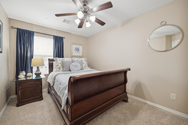 bedroom with ceiling fan and light colored carpet