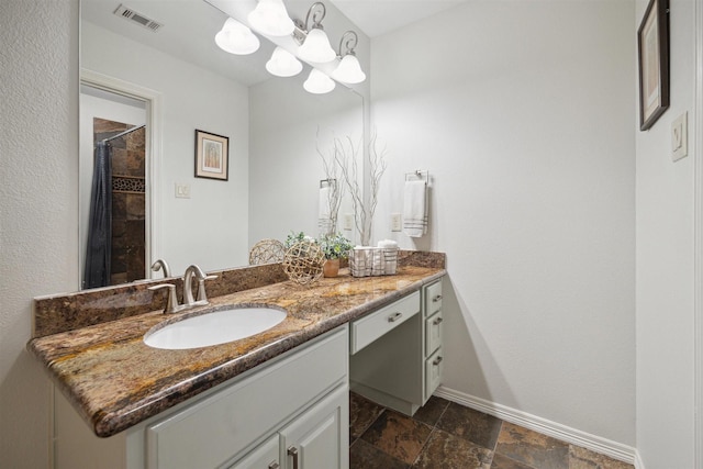 bathroom with a shower with curtain, vanity, and a notable chandelier