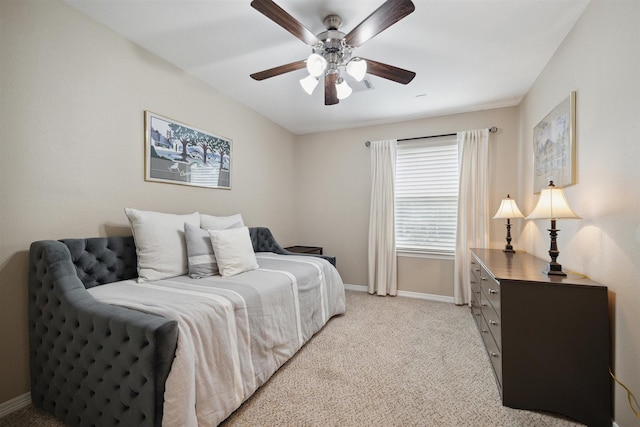 bedroom featuring ceiling fan and light carpet