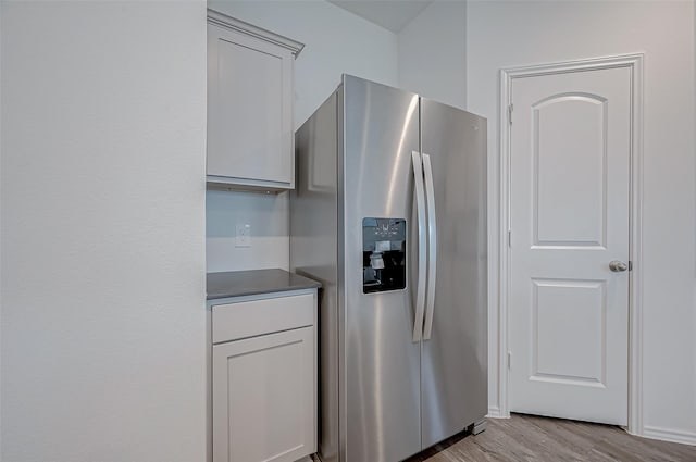 kitchen with stainless steel fridge and light wood-type flooring