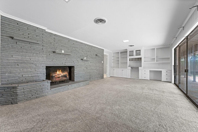 unfurnished living room featuring a fireplace, carpet, and built in features