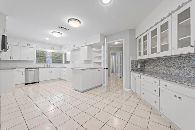 kitchen with sink, white cabinetry, tasteful backsplash, light stone counters, and appliances with stainless steel finishes