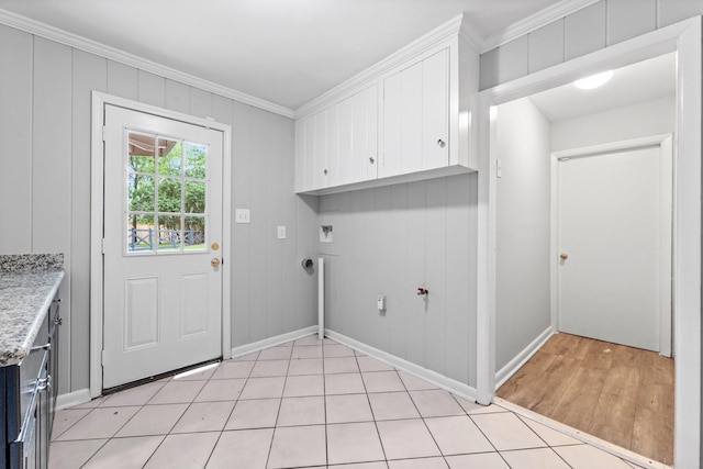 washroom with cabinets, washer hookup, and ornamental molding