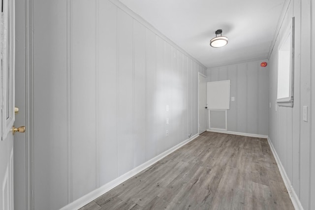 empty room featuring light hardwood / wood-style flooring and ornamental molding