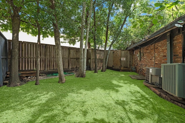 view of yard featuring central air condition unit