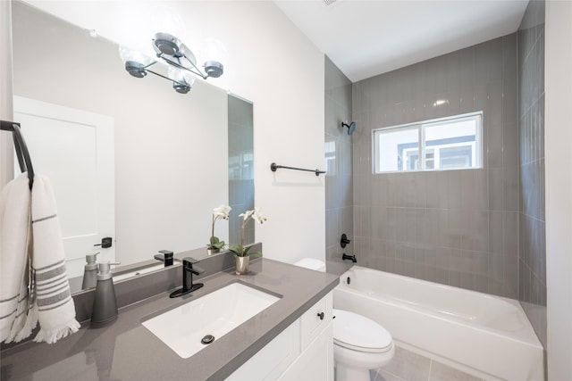 full bathroom featuring vanity, toilet, and tiled shower / bath combo