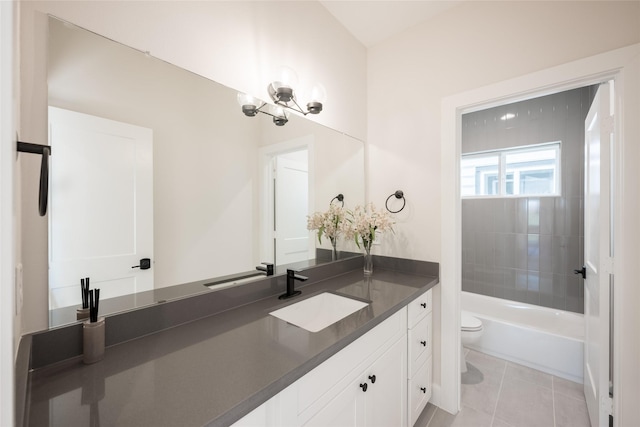 full bathroom featuring vanity, tiled shower / bath combo, tile patterned floors, and toilet