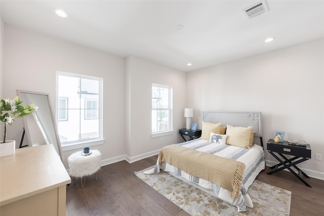 bedroom with dark hardwood / wood-style flooring