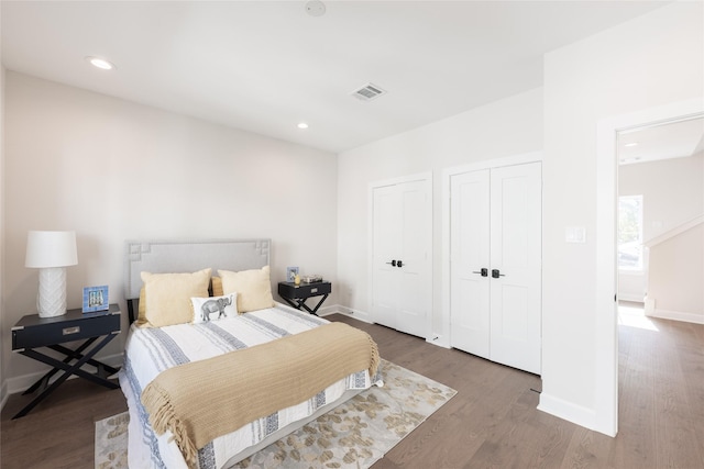 bedroom with dark hardwood / wood-style flooring