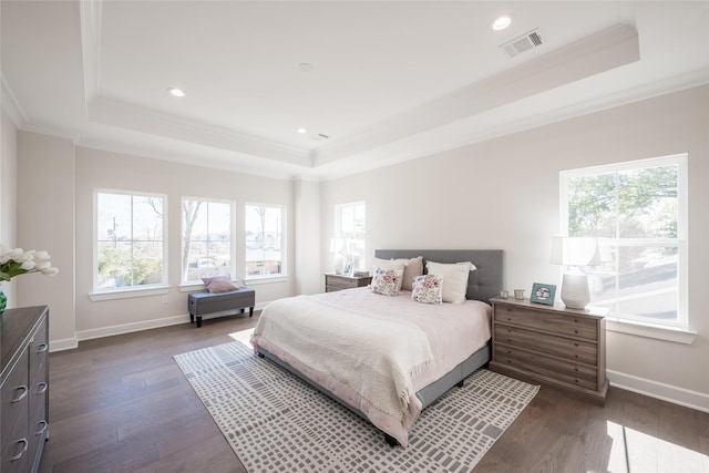 bedroom featuring a tray ceiling, ornamental molding, and dark hardwood / wood-style floors