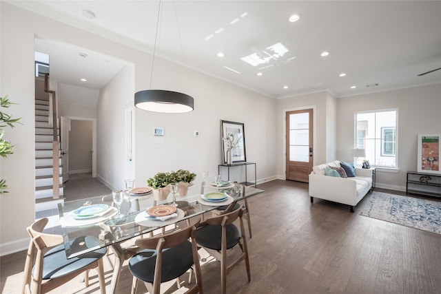 dining space featuring crown molding and dark wood-type flooring