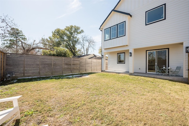 back of property with a patio area and a lawn