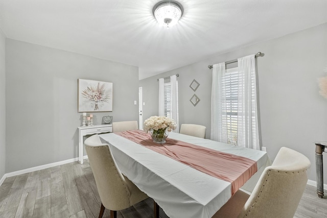 dining room with light wood-style flooring and baseboards