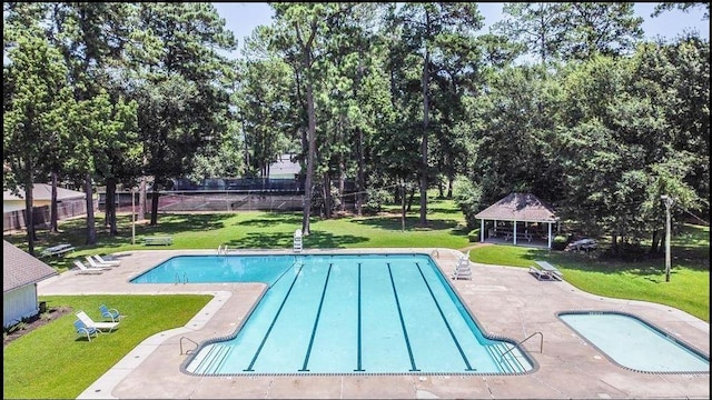 pool with a gazebo, a yard, a patio, and fence